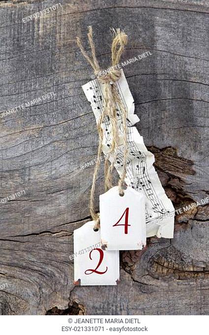 Top view of music sheet and 24 for christmas on wooden background
