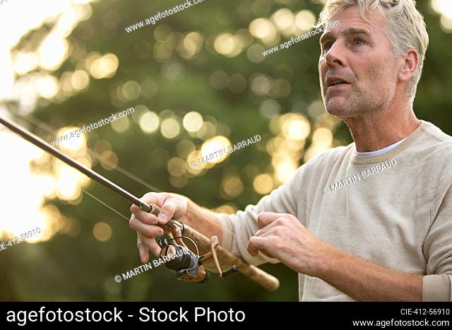 Close up man fly fishing