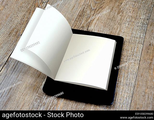 blank page ebook reader on book on wooden background
