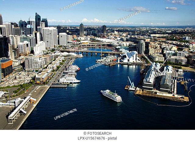 Aerial view of ships and boats in Darling Harbour with view of skyscrapers in Sydney, Australia