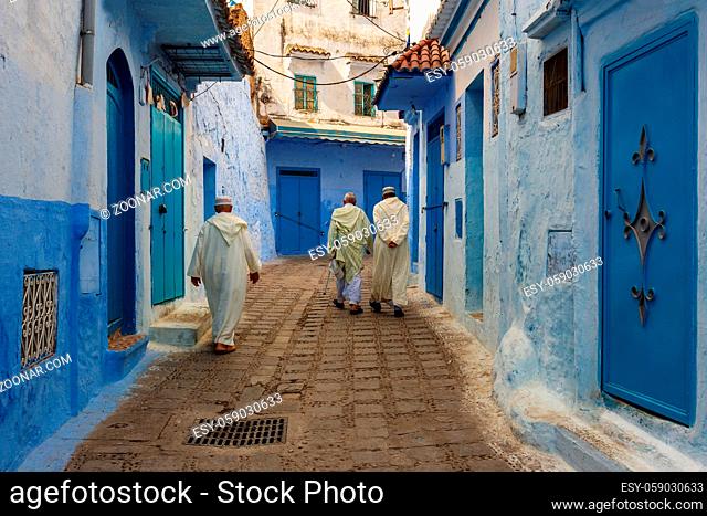 Narrow streets and blue painted houses of Chefchaouen city, Morocco. Most of the streets full of handmade colorful crafts