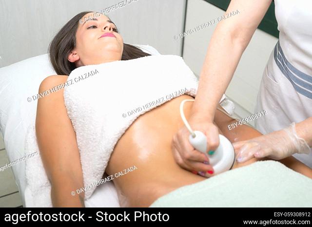 Ultrasound cavitation body contouring treatment. Woman getting anti-cellulite and anti-fat therapy in beauty salon. High quality photo