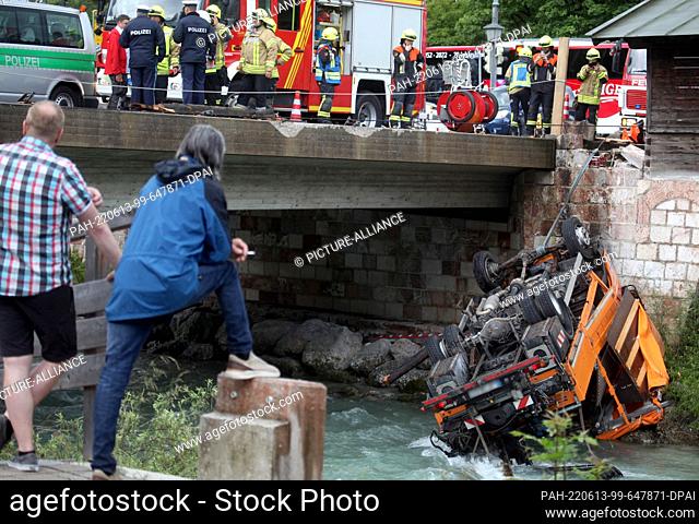 13 June 2022, Bavaria, Berchtesgaden: A truck lies in the riverbed of the Berchtesgadener Ache after an accident. The truck had previously broken through the...