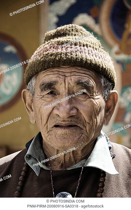 Senior man smiling in a monastery, Likir Monastery, Ladakh, Jammu and Kashmir, India