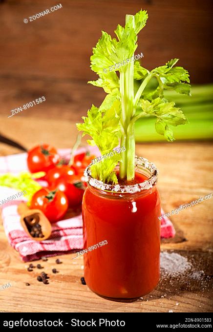 Bloody Mary cocktail on a wooden background