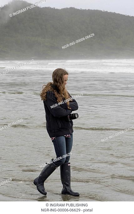 Girl walking on beach, Cox Bay, Pacific Rim National Park Reserve, Tofino, British Columbia, Canada