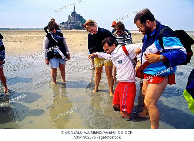 Quicksand Pilgrims crossing on foot the Bay of Mont Saint Michel Manche Department, Basse-Normandie region, Normandy, France, Europe