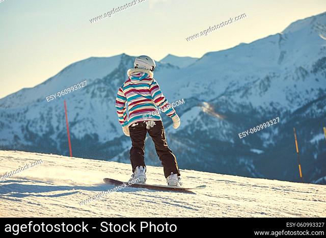 Snowboarding in the alps, soft sunlight