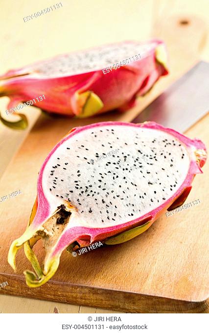 pink pitahaya on wooden table