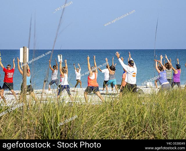 Morning Yoga on Englewood Beach on Manasota Key on the Gulf of Mexico in Englewood FLorida in the United States