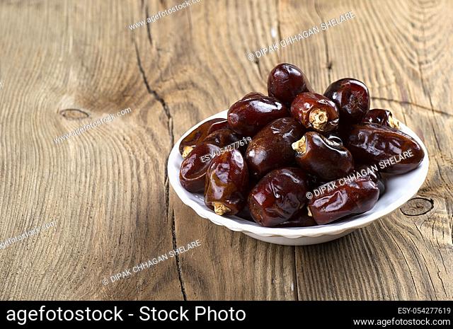 Dates on wooden background. Dried dates fruit