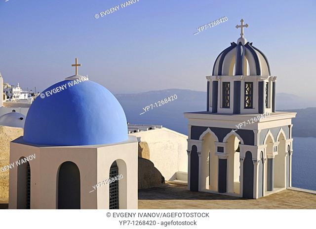 Domes of Orthodox church in Firostefani Fira Santorini with the sea and caldera on background