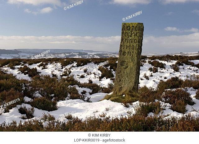 England, North Yorkshire, North York Moors , Snow carpets the moorland around an old Waymarker on Spaunton Moor