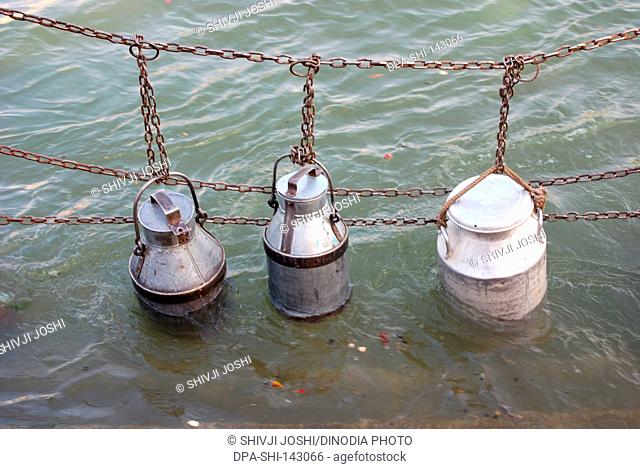 Milk drums kept in Ganga for cooling ; Haridwar ; Uttar Pradesh ; India