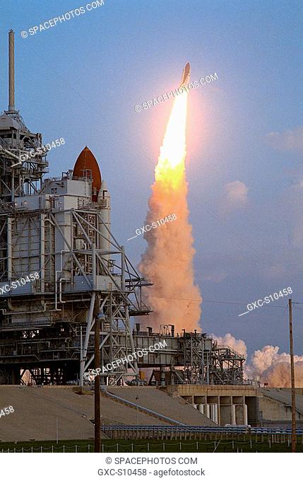 10/06/1990 --- The Space Shuttle Discovery hurtles into space as sister ship Columbia looks on from Launch Pad 39A. Discovery lifted off from pad 39B at 7:47 a
