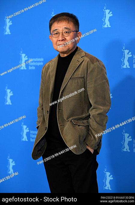 18 February 2023, Berlin: Zhang Lu, director and screenwriter, stands in front of the photo wall during the photo session for the film ""Bai Ta Zhi Guang"" (The...