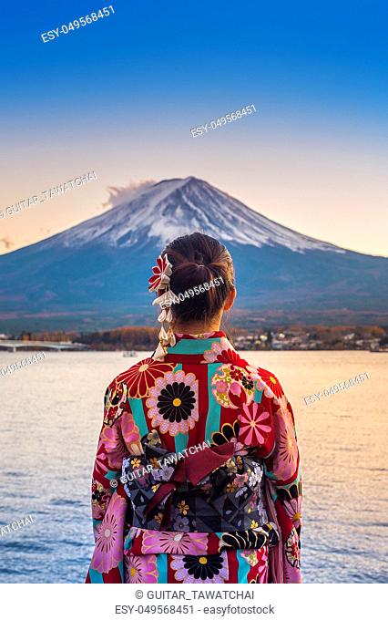 Asian woman wearing japanese traditional kimono at Fuji mountain. Sunset at Kawaguchiko lake in Japan