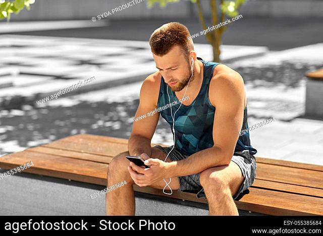 young athlete man with earphones and smartphone