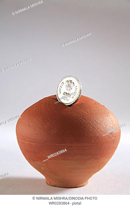 Concept , gullak clay bag or box for keeping wealth with coin on white background