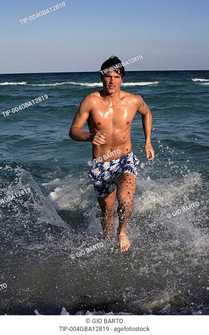 Man running in shallow water