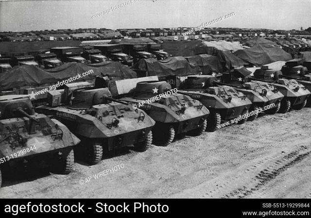 Await Invasion -- Mechanized units of all types are lined up in this supply depot somewhere in England ready to be put into use in the offensive against the...