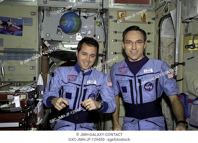 Astronauts Daniel W. Bursch and Carl E. Walz, both Expedition Four flight engineers, are photographed in the Zvezda Service Module on the International Space...