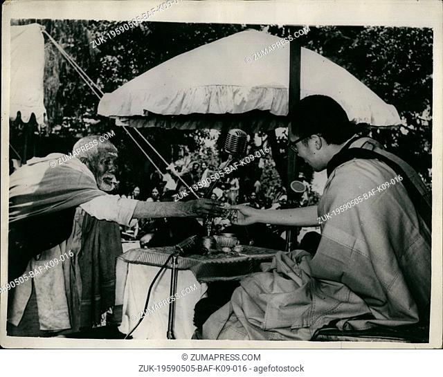 May 05, 1959 - Dalai Lama at Buddha Purnima Celebrations: Photo shows A humble offering of a flower to the Dalai Lama, at the Buddha Purnima Celebrations in...