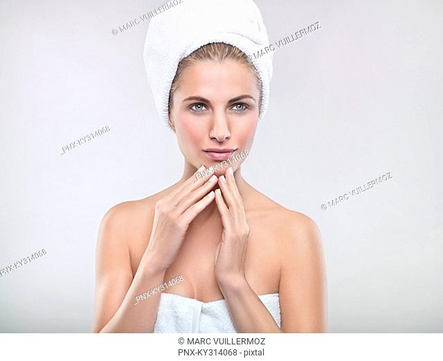 Young woman wrapped in towels