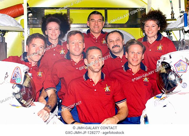 Seven astronauts and a cosmonaut representing Rosaviakosmos take a break in joint activities involving the Expedition Two and STS-104 crews to pose for an...