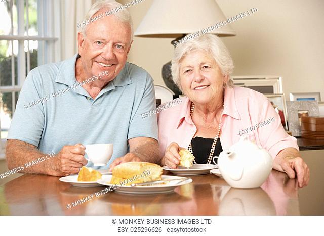 Retired Senior Couple Enjoying Afternoon Tea Together At Home