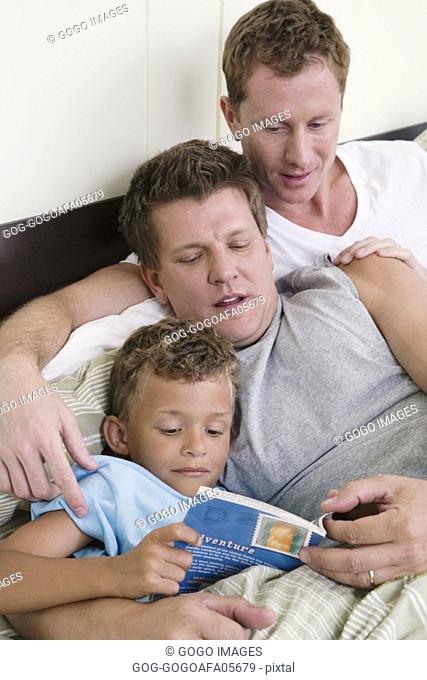 Gay couple reading to their son