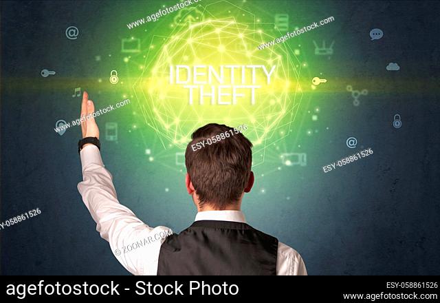 Rear view of a businessman with IDENTITY THEFT inscription, online security concept