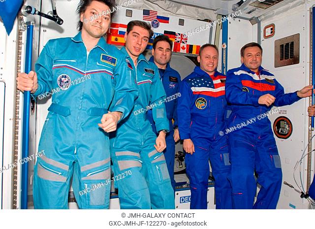 Crewmembers aboard the International Space Station pose for a group portrait during the ceremony of Changing-of-Command from Expedition 17 to Expedition 18 in...