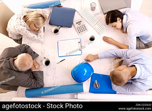 Tired businesspeople at meeting, sleeping leaning on table, high angle view