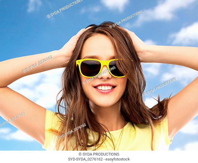 teenage girl in yellow sunglasses and t-shirt
