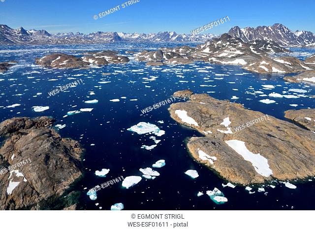 Greenland, East Greenland, Aerial view of Ammassalik island and fjord with pack or drift ice