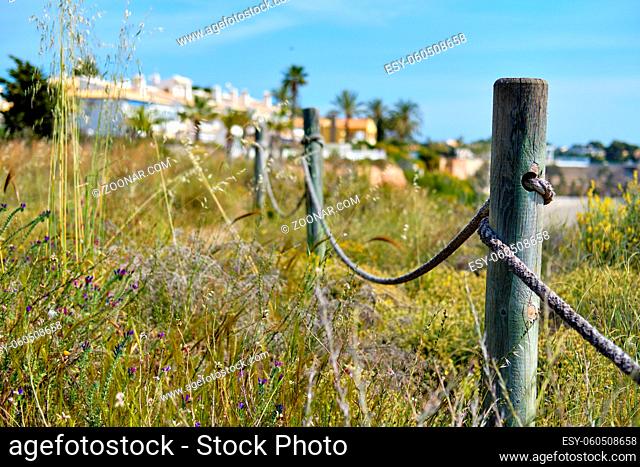 Wooden fencing with rope along the pathway