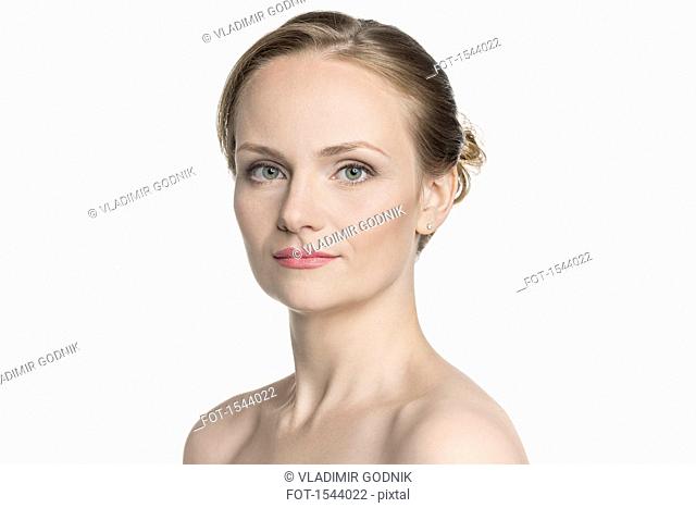 Portrait of shirtless beautiful woman standing against white background