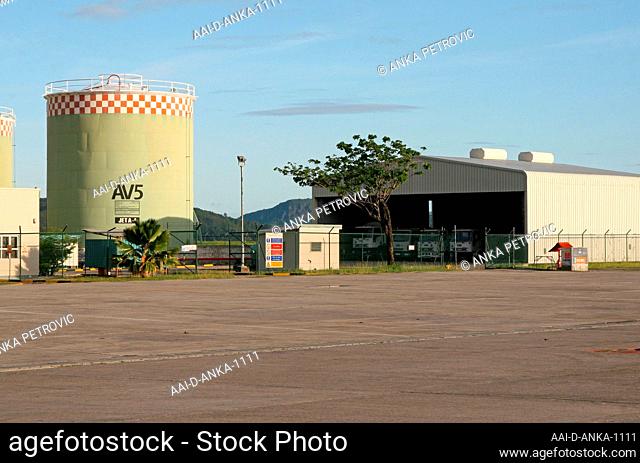 Cylindrical petrol tank and truck garage at Mahe Airport, Seychelles