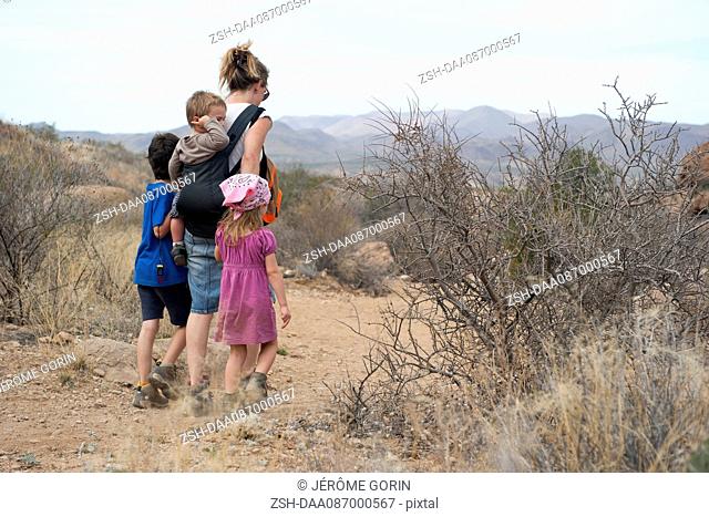 Mother and children hiking in the desert, Big Bend National Park, Texas, USA
