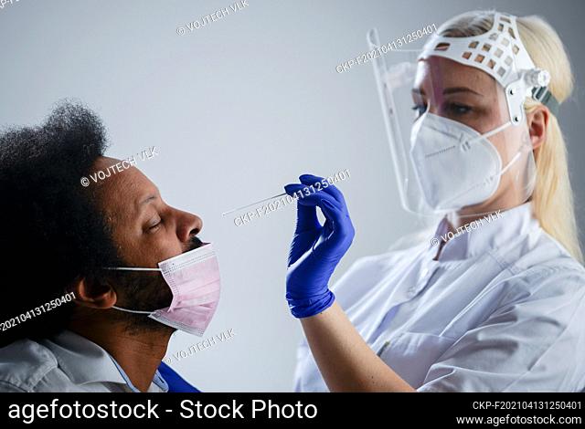 Nurse Making PCR Covid-19 Test For AFRO AMERICAN, White Background (CTK Photo/Vojtech Vlk)