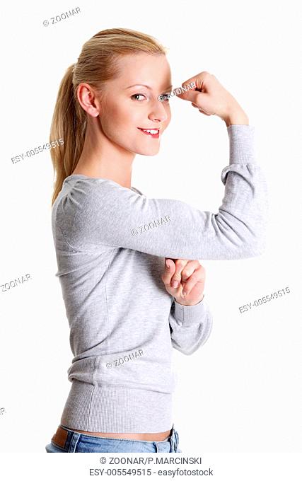 Cute young smiling woman showing her biceps