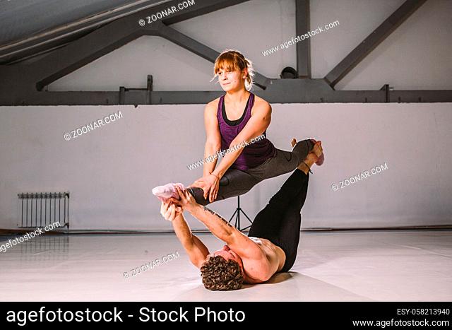 Yogi couple practice. Couple young sporty peoplepracticing acrobatic yoga lesson with partner, man and woman in yogi exercise, arm balance pose
