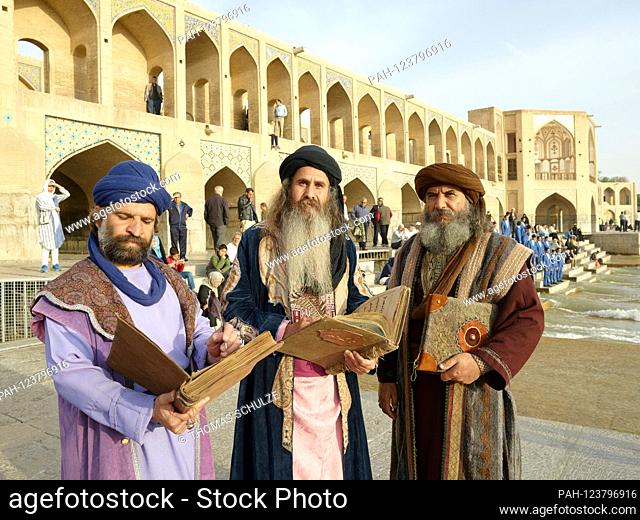 Men in historical costumes in front of the Khadju Bridge over the Zayandeh Rud River in the Iranian city of Isfahan, taken on April 25, 2017
