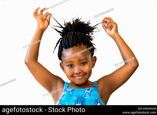 Close up portrait little african girl playing with braided hair.Isolated against white background