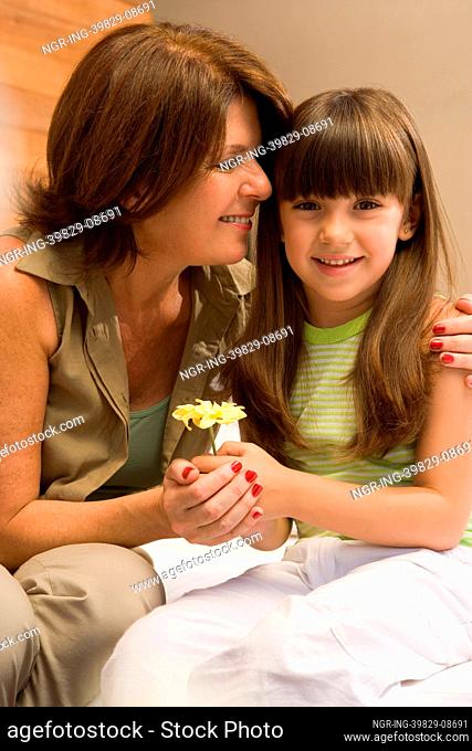 Girl and grandmother with flower
