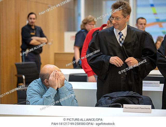 17 December 2018, Bavaria, München: One of the defendants in the trial for the robbery murder of Meiling sits next to his lawyer in the courtroom of the...