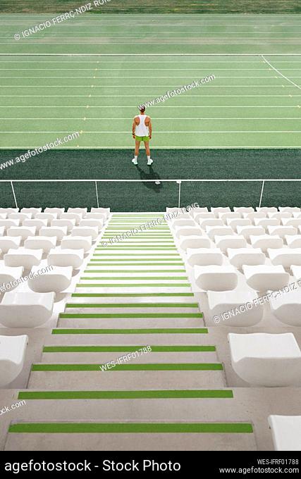Athlete standing on running track at sports field