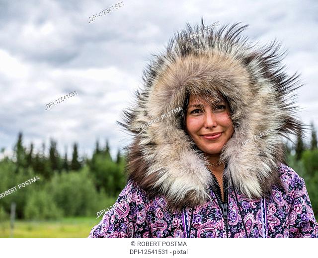 First nation woman dressed in handmade traditional coat; Mayo, Yukon, Canada