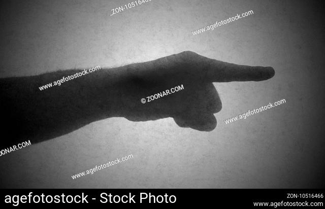 Silhouette behind a transparent paper - Finger pointing